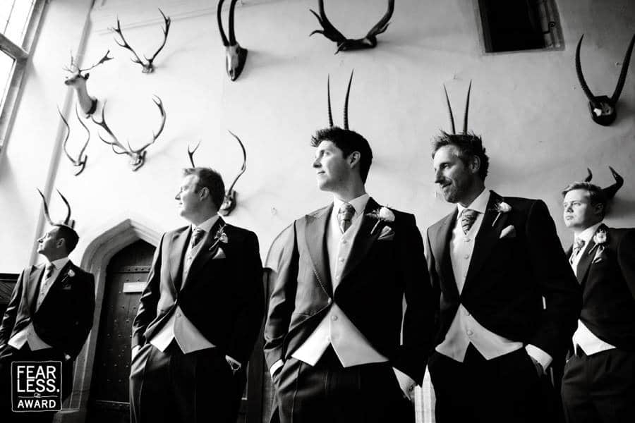 gromsmen with antlers behind their heads at brympton house in somerset
