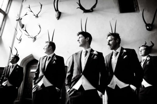groomsmen with antlers behind their heads at brympton house in somerset