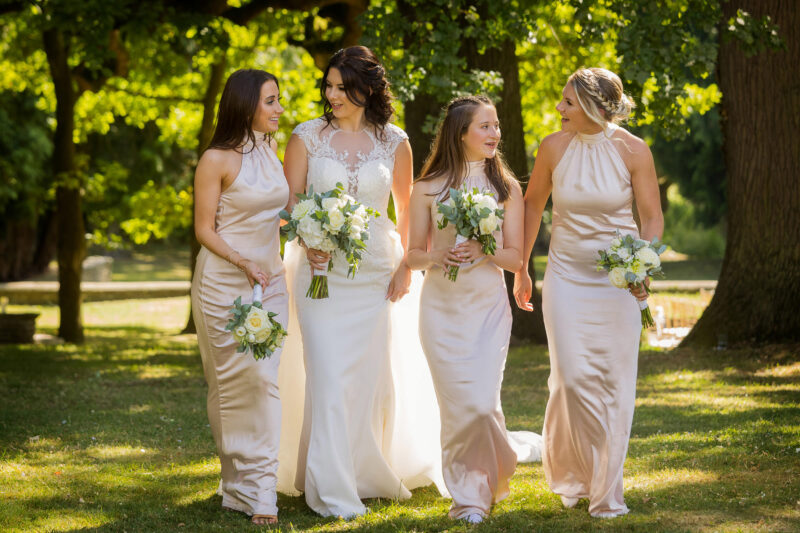 bride walking with bridesmaids at eastington park
