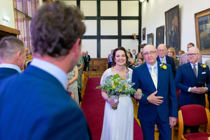 bride walking down the aisle with her father at Tudor Hall at Taunton registry office