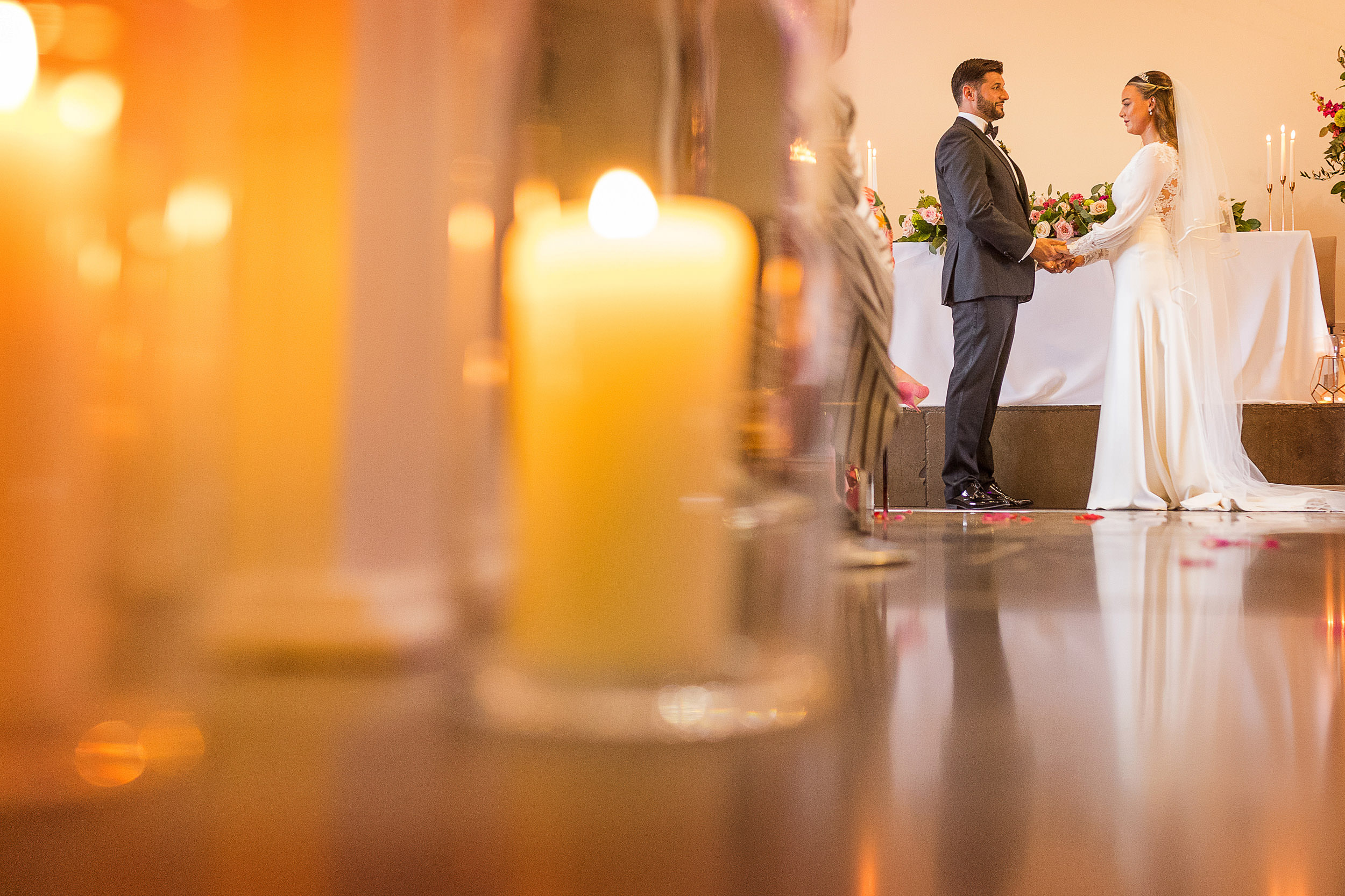 BRIDE AND GROOM HOLDING HANDS DURING WEDDING CEREMONY AT CLIFTON OBSERVATORY. CLIFTON OBSERVATORY WEDDING PHOTOGRAPHY