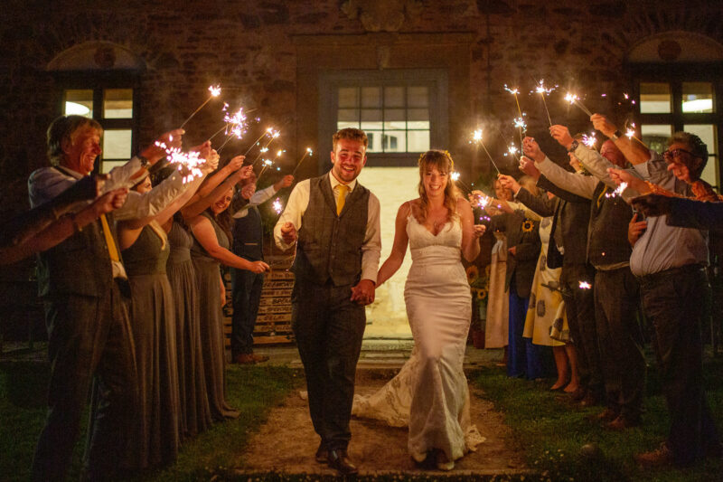 bride and groom with sparklers in front of Bampflyde Hall  at Hestercombe gardens in somerset 