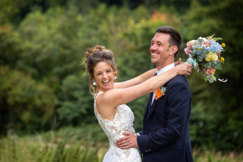 bride and groom having fun at ashley wood farm in wiltshire. ashley wood farm wedding photographer